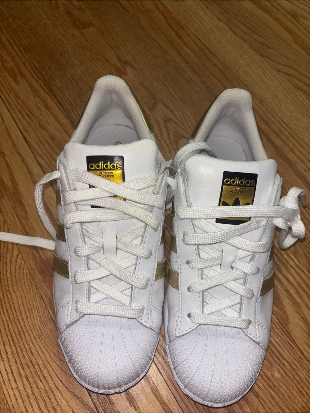 adidas Women's White Sneakers with Gold Stripe Accents